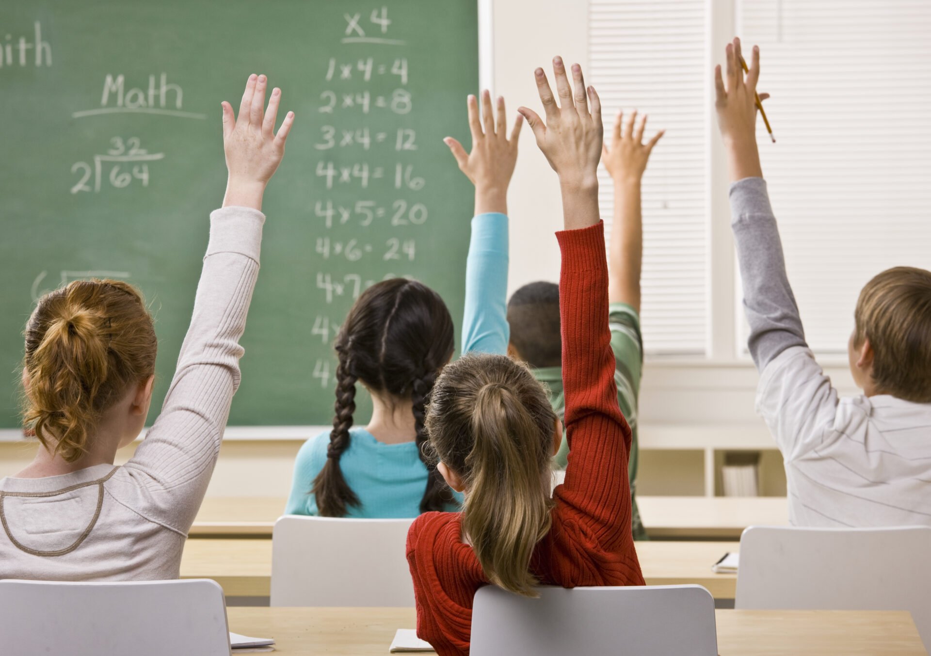 Upper Elementary students eager to answer questions in math class