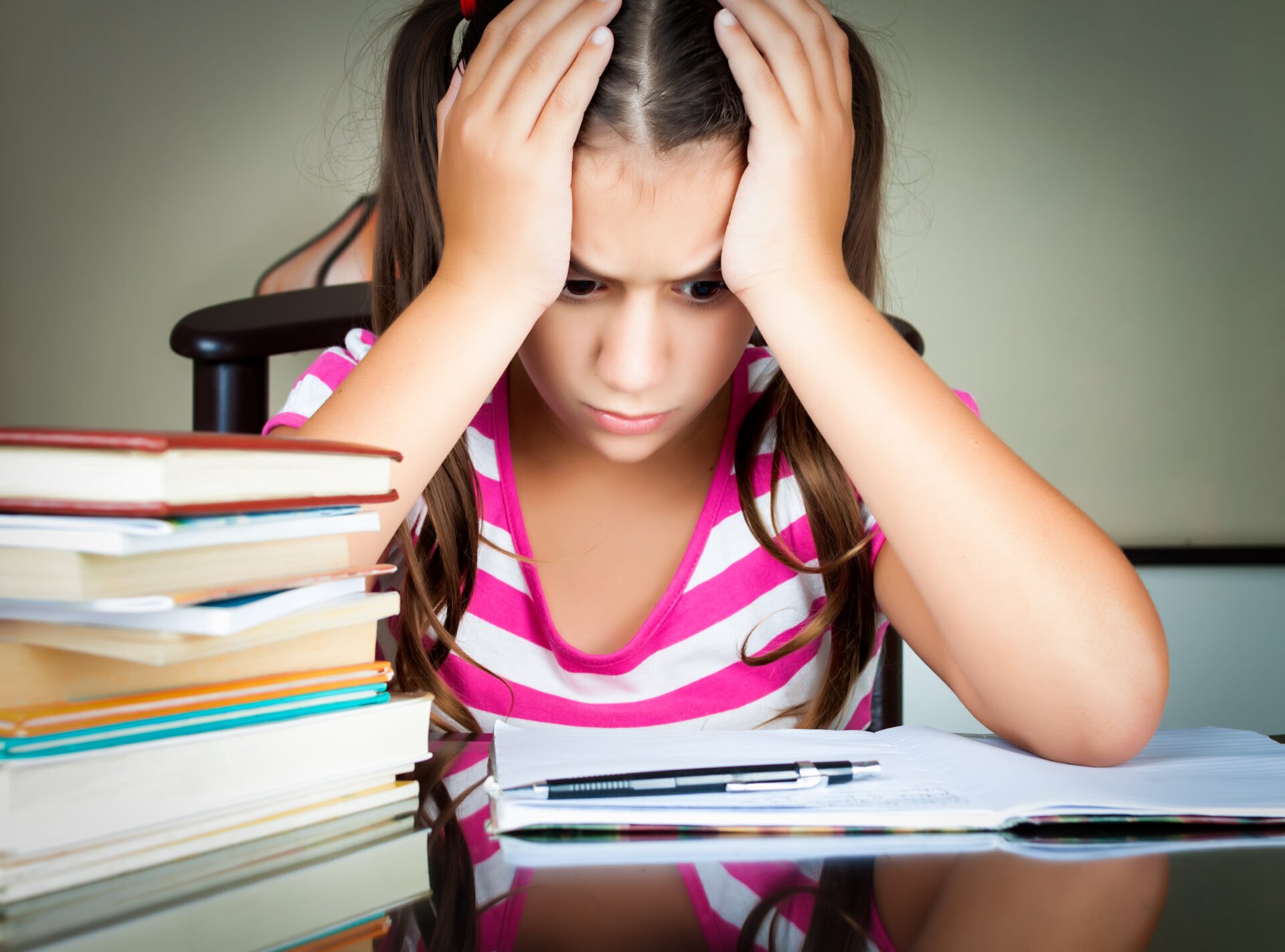 anxious, reluctant math student burying her head in her hands